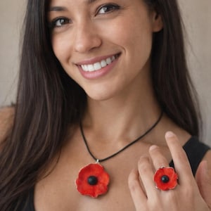 ONE OF A KIND - Artisanal red ceramic flower pendant, on a black string. Assorted adjustable ring.