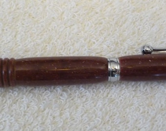 May include: A brown and silver pen with a textured brown barrel and a silver clip. The pen has a silver tip and a silver cap.