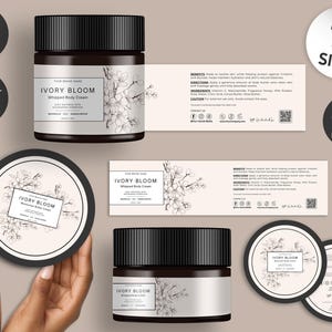 May include: A product mockup featuring a jar of Ivory Bloom Whipped Body Cream with a black lid, a round label, and a matching lid. The label includes the product name and floral illustrations. Additional items include a label with product information and a sticker that says "14 Sizes".