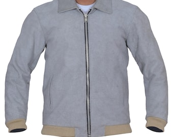 May include: A light grey suede jacket with a collared neckline and a full-length zip. The jacket has tan ribbed cuffs and a matching ribbed hem. The jacket features two side pockets and is a classic outerwear piece.