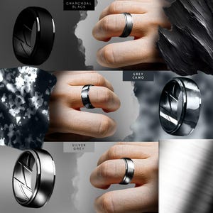 May include: Four different color variations of a black silicone ring with a silver metal band. The ring is shown on a hand wearing a camouflage pattern shirt. The colors are Charcoal Black, Grey Camo, Silver Grey, and a plain silver ring.