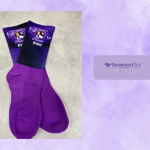 May include: A pair of purple crew socks featuring a black gradient at the top cuff. The cuff displays a circular photo, the name Karen Meadows, and the text In Loving Memory. A logo for Diamond Cut Customs is visible in the corner.