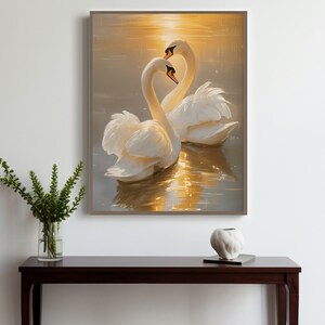 May include: Two white swans with their necks intertwined, swimming in golden sunset water. The swans are facing each other, creating a heart shape with their necks.