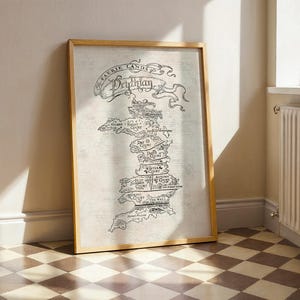 May include: A framed map print with a light wood frame. The map is a detailed black and white illustration of a fantasy land, with the words "Faerie Lands" and "Brythian" at the top. The map is leaning against a white wall.