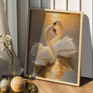 May include: A framed painting depicting two white swans with their necks intertwined, set against a golden sunset backdrop. The swans are in a lake with reflections of the sunset.