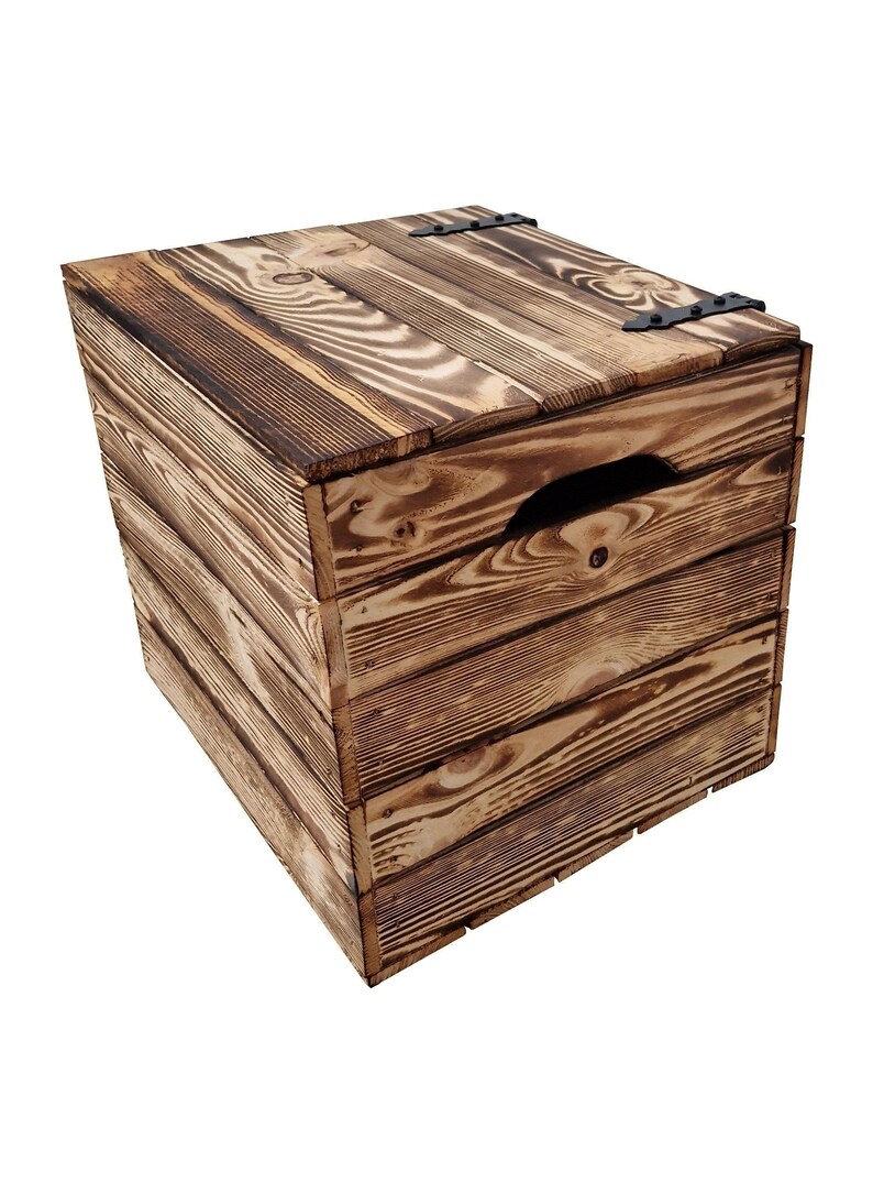 May include: A rustic wooden storage box with a hinged lid and a handle cut into the side. The box is constructed from horizontal wooden planks with a dark brown finish, and black metal hinges.