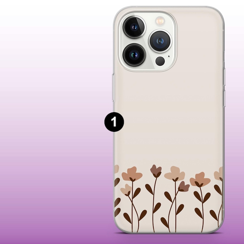 May include: A clear phone case with a white background and a floral design in brown and beige. The case has a cutout for the camera lens.