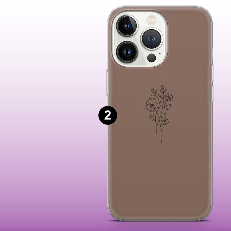 May include: A clear phone case with a brown back and a floral design. The case is designed for an iPhone with a triple lens camera system.