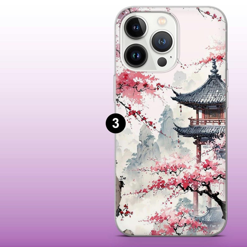 May include: A clear phone case with a white background and a design of a Japanese pagoda with cherry blossoms. The case has a raised camera bump with three lenses.