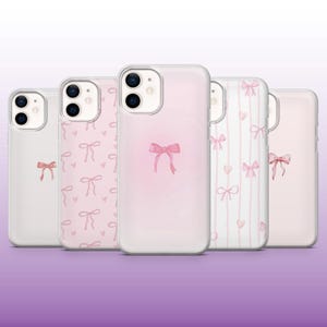 May include: Four clear phone cases with pink bow designs. The cases have different patterns, including a single bow, a repeating bow pattern, and a vertical stripe pattern with bows.