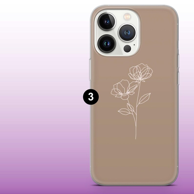 May include: A brown phone case with a white outline of two flowers. The phone case has a clear back and a raised camera bump.