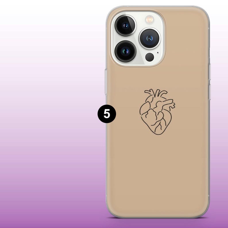 May include: A beige phone case with a clear back and a black outline of a heart on the back.
