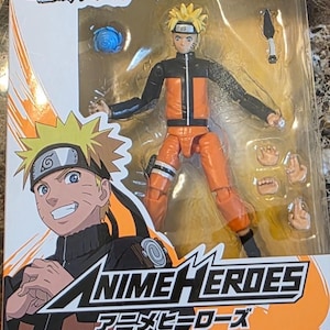Op de afbeelding: Naruto Shippuden Anime Heroes actiefiguur in verpakking. De figuur is van Uzumaki Naruto, gekleed in een oranje en zwarte outfit. De verpakking toont het Naruto Shippuden logo en de woorden Anime Heroes.