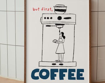 May include: A framed art print with a coffee theme. The print features a black and white illustration of a coffee machine and a person holding a cup. The words "but first," are in red, and "COFFEE" is in blue.
