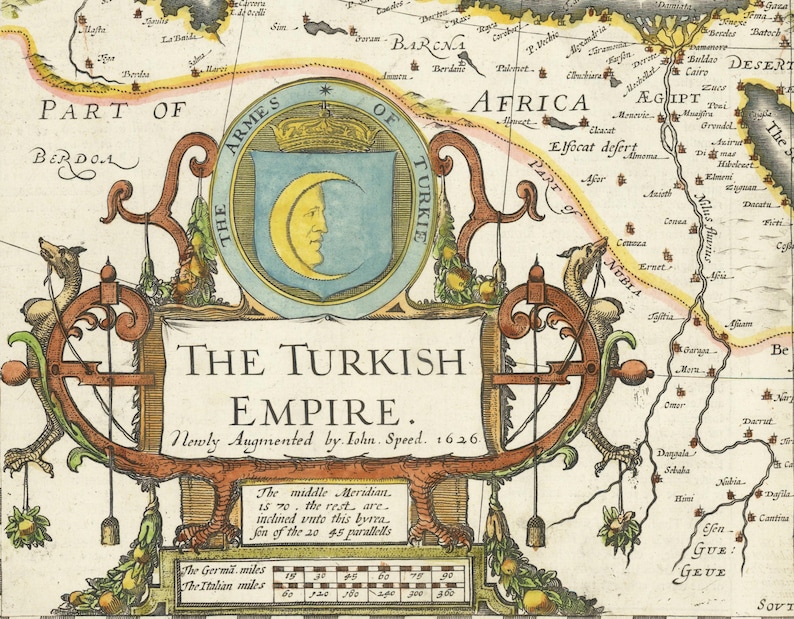 May include: A detailed, antique map of the Turkish Empire, with text that reads "The Turkish Empire. Newly Augmented by John Speed. 1626." The map features ornate scrollwork, a crest with a crescent moon, and geographical details.
