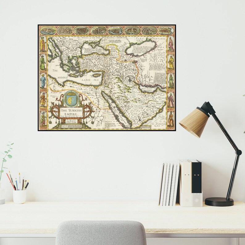 May include: A framed vintage map of the Turkish Empire, featuring detailed cartography in shades of beige, brown, and green. The map includes text and decorative borders with figures. The title "The Turkish Empire" is prominently displayed.