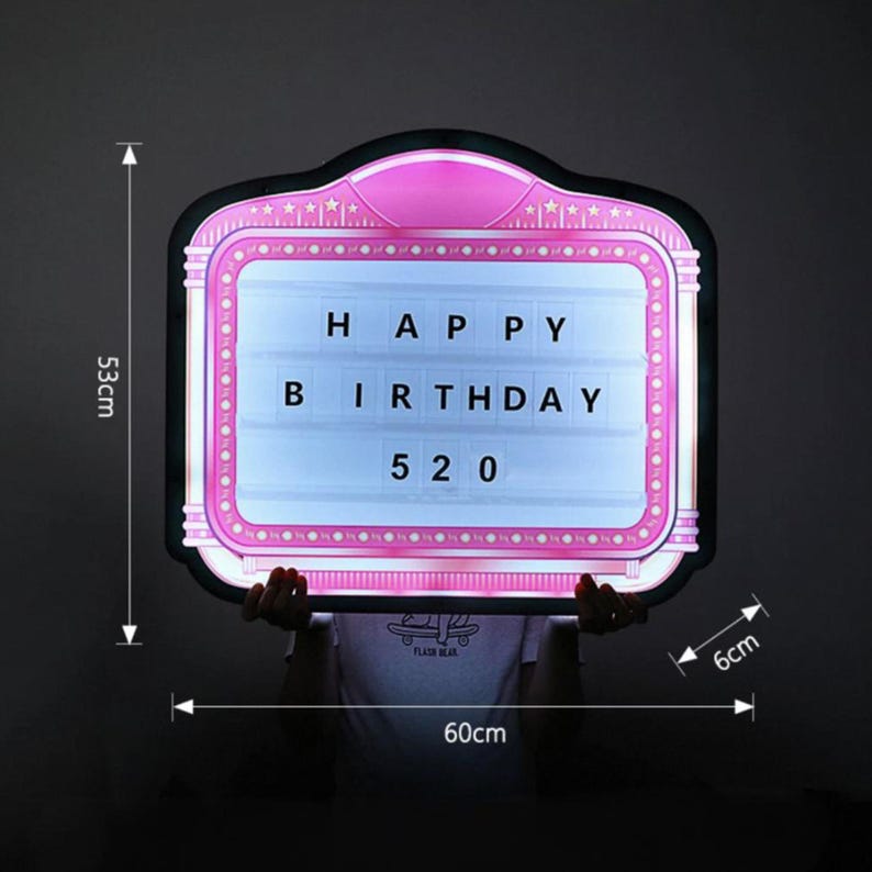 May include: A pink and black light-up sign with the words "HAPPY BIRTHDAY 520". The sign is 23.6 inches wide, 20.9 inches tall, and 2.4 inches thick. The sign has a retro theater marquee design.