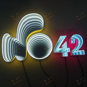 May include: Illuminated neon sign featuring the word "no" and the number "42". The "no" is a stylized design with yellow and white neon lights. The "42" is in blue and pink neon lights, with black wires.