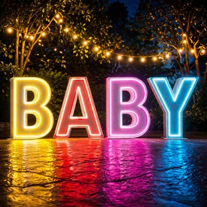 May include: Large, illuminated letters spelling "BABY" in a garden setting. The letters are outlined with vibrant neon colors: yellow, red, pink, and blue. The scene is lit by string lights and has a reflective surface.
