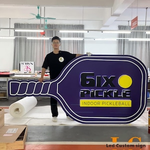 Professional LED channel letter business sign glowing at night, custom storefront logo signage designed for outdoor advertising.