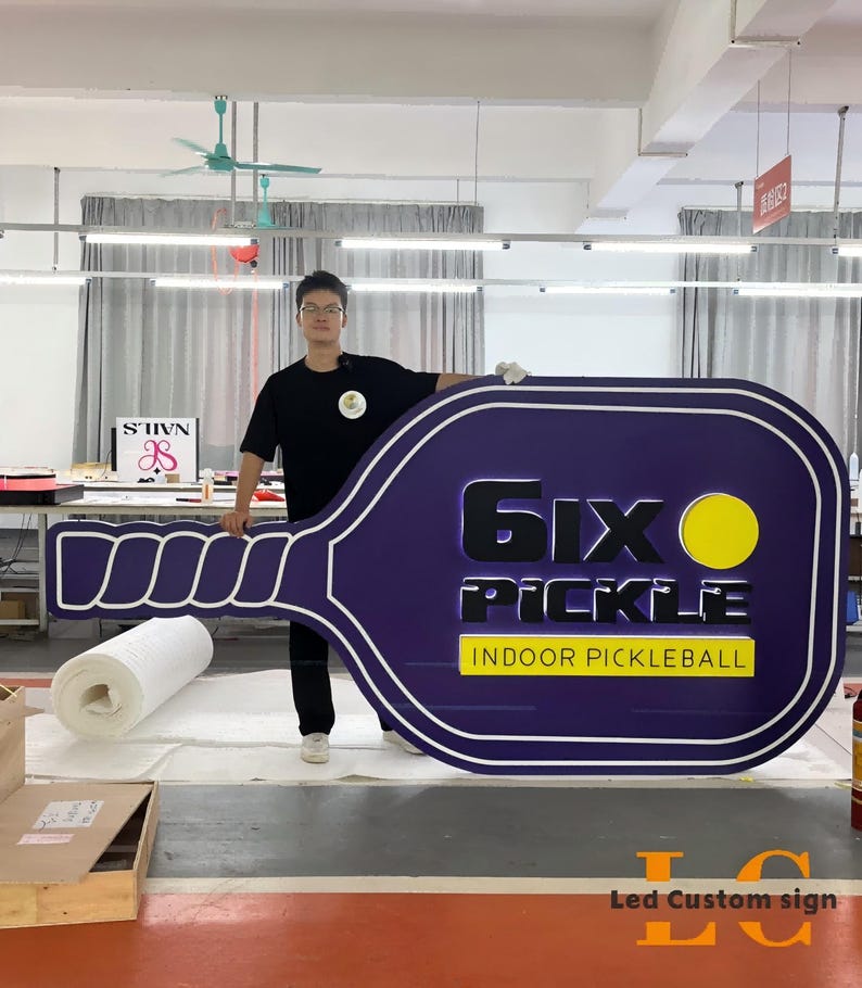 Professional LED channel letter business sign glowing at night, custom storefront logo signage designed for outdoor advertising.