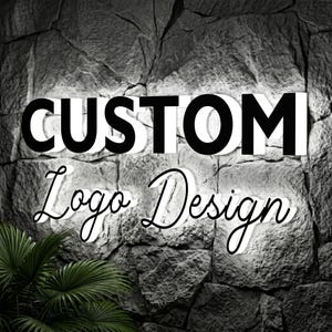 May include: A wall-mounted sign featuring the text CUSTOM in bold, black, block capital letters and the text Logo Design in a black, cursive script font. Both lines of text are illuminated with a bright white glow against a dark stone wall.