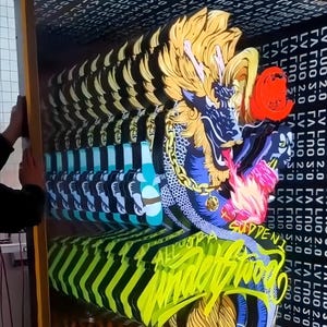 May include: A multi-layered, illuminated wall art piece featuring a stylised dragon with yellow hair, blue scales, and a gold chain. The artwork includes the text "LV LUO 2.0" repeated in the background and the phrase "ALL OF A SUDDEN" in yellow script.