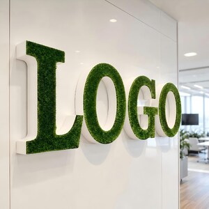 May include: A three-dimensional wall sign spelling the word Logo in large capital letters. Each letter features a white side profile and a front surface covered in a textured, vibrant green artificial moss material mounted on a white wall.