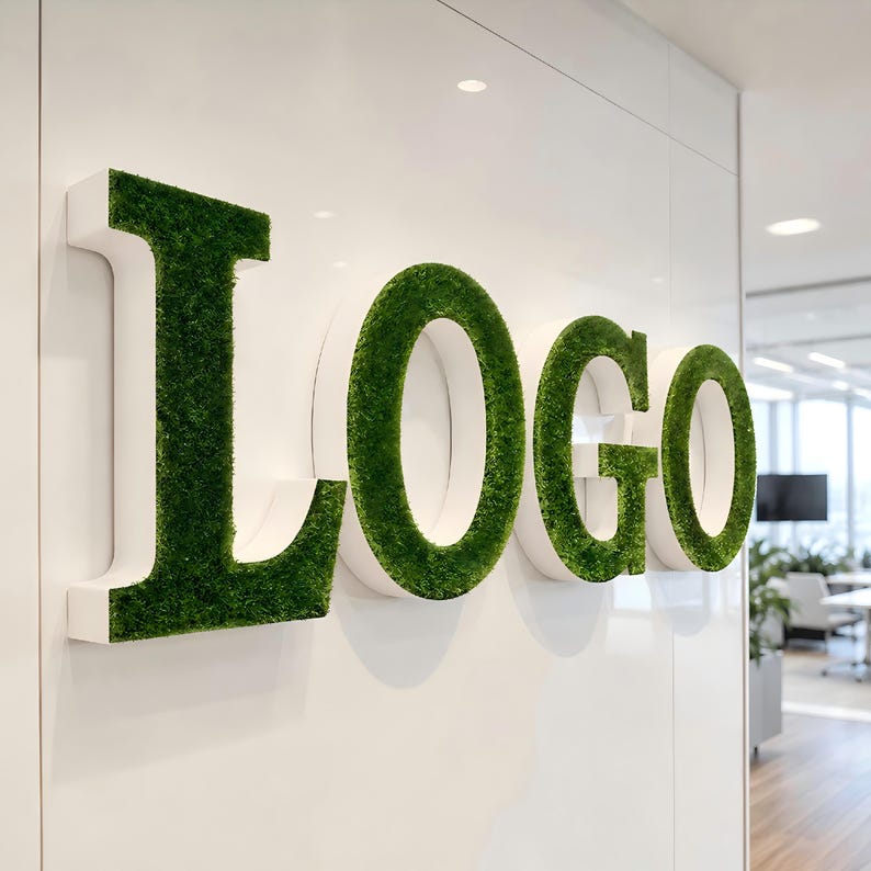 May include: A three-dimensional wall sign spelling the word Logo in large capital letters. Each letter features a white side profile and a front surface covered in a textured, vibrant green artificial moss material mounted on a white wall.