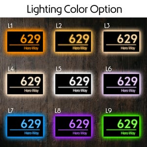 May include: A rectangular house number sign displaying the text 629 and Hero Way, presented in nine different LED lighting color options labeled L1 through L9, including orange, yellow, warm white, cool white, purple, blue, and green.