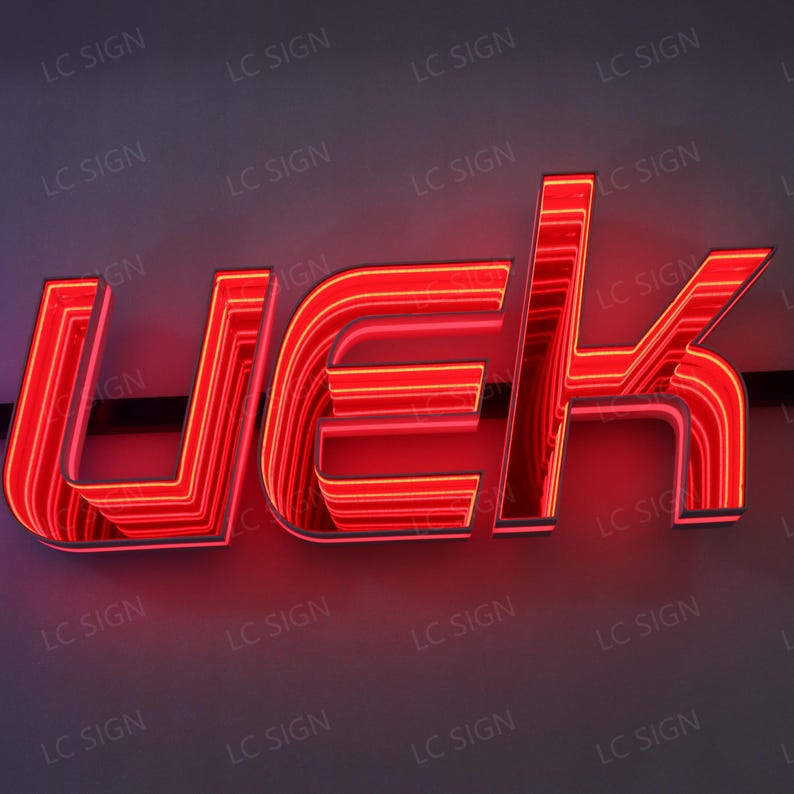 May include: A red neon sign displaying the letters UEK. The sign has a layered design with bright red illumination, creating a striking visual effect. The background is a neutral gray, and the sign is labeled with "LC SIGN".