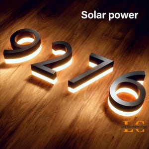 Illuminated house numbers with warm halo lighting effect at night, waterproof outdoor address numbers for modern home.