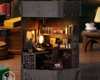 May include: Miniature diorama of a cozy study with a desk, rocking chair, and bookshelves. The scene includes a typewriter, books, and a small lamp, all within a detailed, enclosed structure. The diorama is made of wood and has a warm, inviting ambiance.