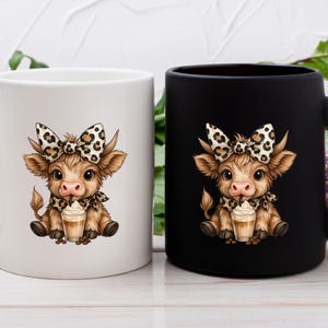 May include: Two ceramic mugs, one white and one black, each featuring a cartoon cow illustration. The cow has a bow, scarf, and is holding a drink. The mugs are on a white wooden surface.