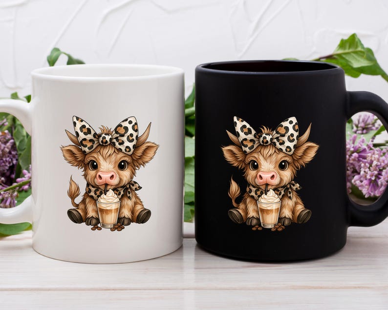 May include: Two ceramic mugs, one white and one black, each featuring a cartoon cow illustration. The cow has a bow, scarf, and is holding a drink. The mugs are on a white wooden surface.
