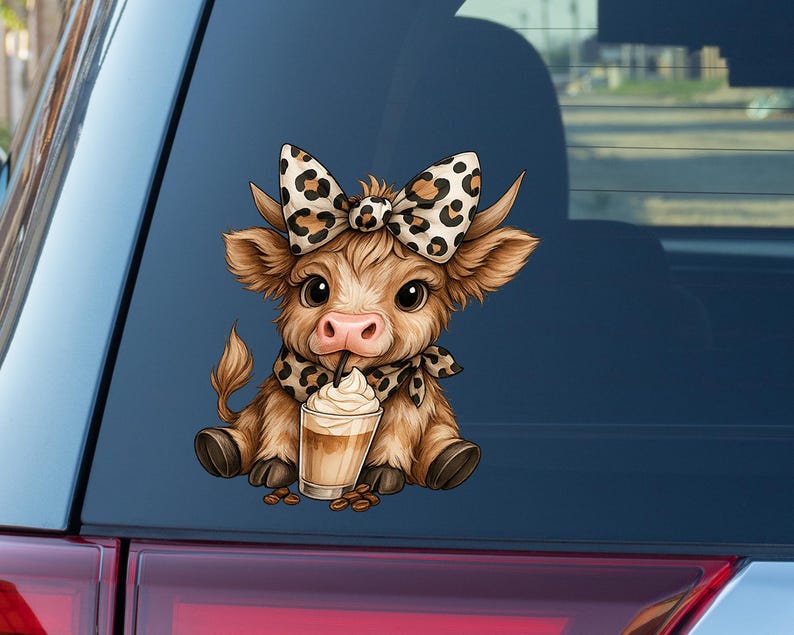 May include: A brown cartoon cow sticker with a large bow and scarf, both with a leopard print design. The cow is drinking a coffee drink with whipped cream. Coffee beans are scattered around the drink.