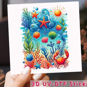 May include: A colorful sticker featuring an underwater scene with a crab, starfish, seashells, and seaweed. The design includes a sun, bubbles, and anchors. The text "3D UV-DTF Sticker" is at the bottom.
