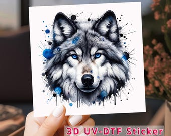 May include: A 3D UV-DTF sticker featuring a wolf's head with blue and black watercolor splatter accents.