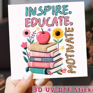 May include: A 3D UV-DTF sticker with a stack of colorful books, a red apple, and flowers. The text "Inspire. Educate. Motivate." is written in a decorative font.