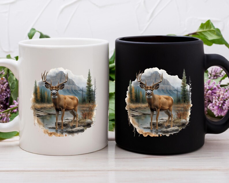 May include: Two ceramic coffee mugs with a white and black background. Both mugs feature a watercolor illustration of a deer standing in a forest setting.