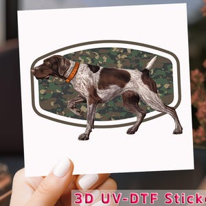 May include: A 3D UV-DTF sticker featuring a brown and white German Shorthaired Pointer dog with a camouflage background.
