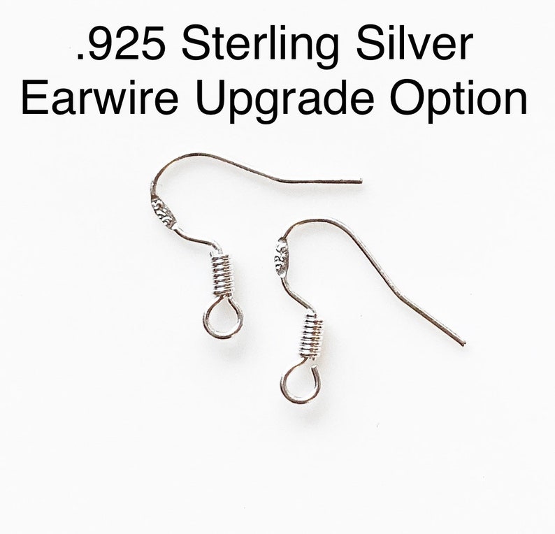 May include: Two silver ear wires with a spring closure. The ear wires are marked with .925, indicating they are made of sterling silver.