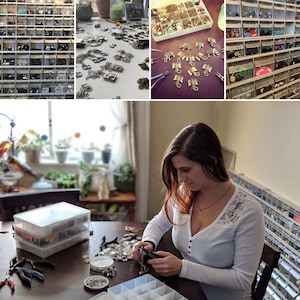 May include: A woman is working on a jewellery project at a table. She is surrounded by small containers filled with beads, charms, and other jewellery making supplies. The table is covered in a variety of jewellery pieces, including necklaces, bracelets, and earrings.