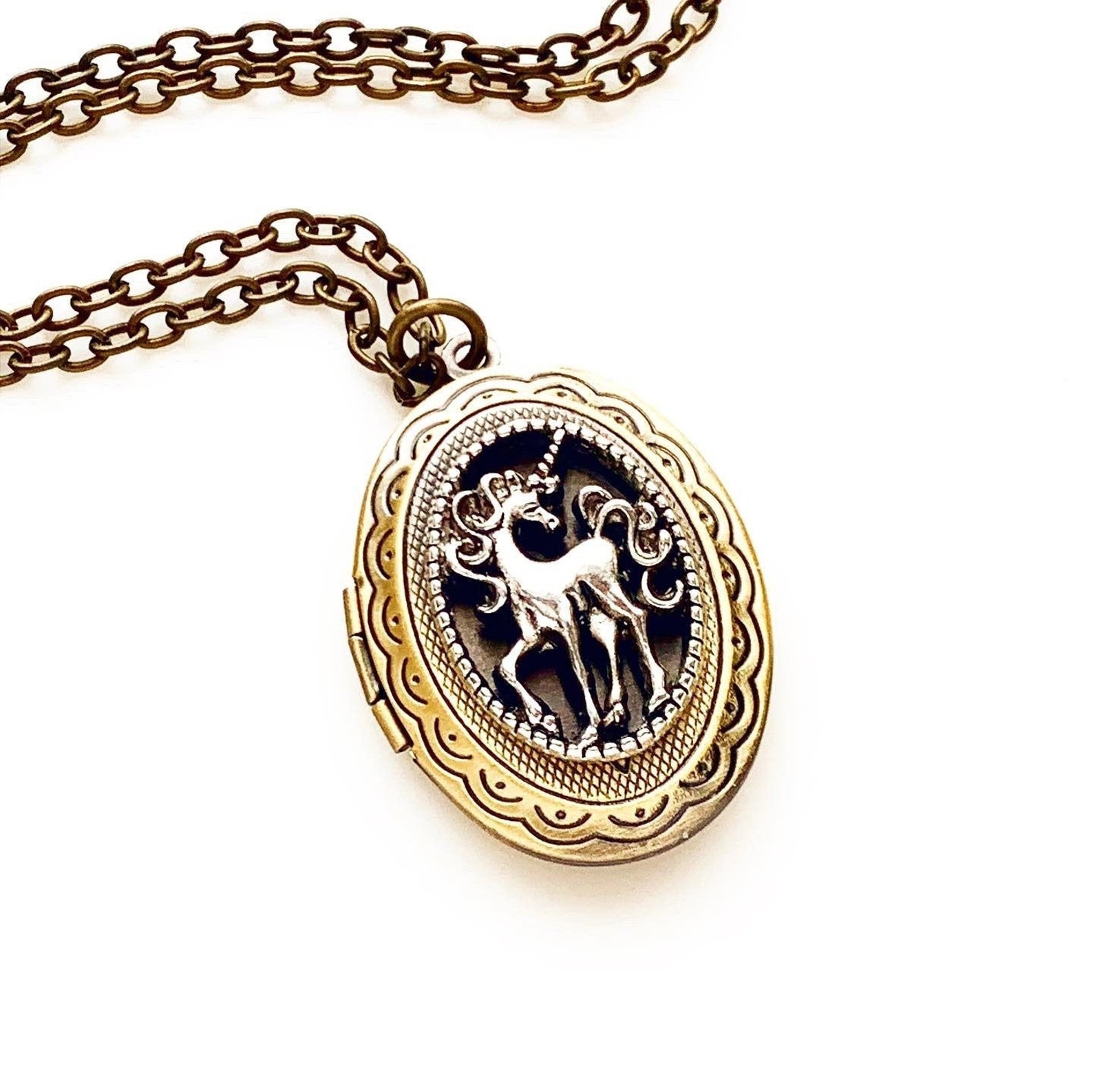 gold locket with a unicorn inside