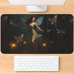 May include: A black rectangular mousepad featuring a fantasy scene with a fairy in a flowing green dress, surrounded by butterflies and dragonfly keys. The background is a dark forest with glowing lanterns and stars.