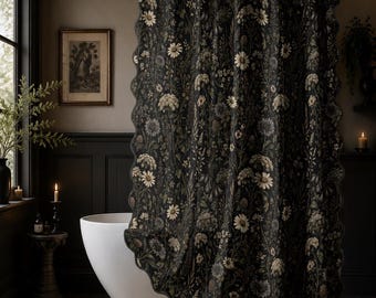 May include: A dark charcoal gray shower curtain featuring a detailed botanical print of white daisies, wildflowers, and green foliage. The curtain has a scalloped edge and is suspended from a metallic rod by a series of white circular rings.