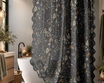 May include: A dark gray shower curtain featuring a repeating pattern of white and muted orange flowers, leaves, and butterflies. The curtain has a scalloped edge and is suspended from a black rod with white rings, creating a decorative bathroom accent.