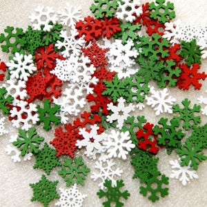 May include: A collection of red, white, and green snowflake-shaped decorations. The snowflakes vary in size and design, creating a festive and seasonal display. Ideal for holiday crafts and winter-themed projects.