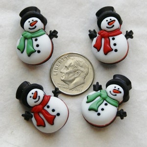May include: Four snowman-shaped decorative buttons. Each snowman has a black top hat, black arms, and a scarf in either red or green. The snowmen have black button eyes and a carrot nose. A US dime is included for size reference.