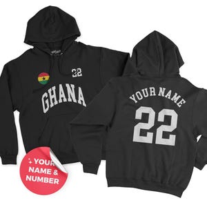 May include: Black hooded sweatshirt with the word "GHANA" in white block letters, the number "22", and a Ghana flag emblem. The back of the sweatshirt has the text "YOUR NAME" above the number "22".